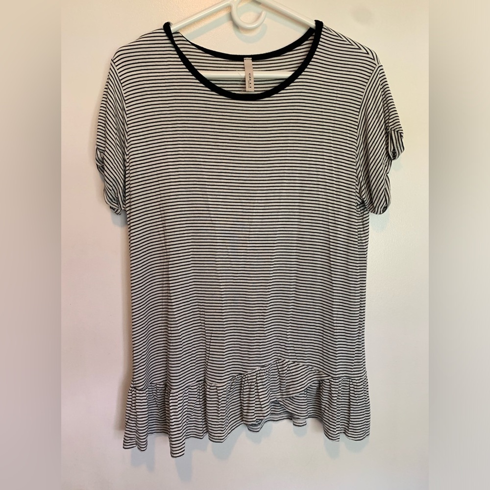 Black and white striped shirt with ruffles on bottom